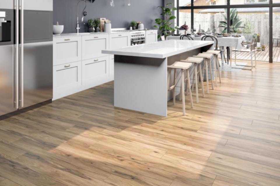 Warm -toned wood look flooring in kitchen with modern decor.